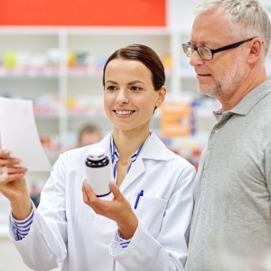 pharmacist providing information to patient about medicine