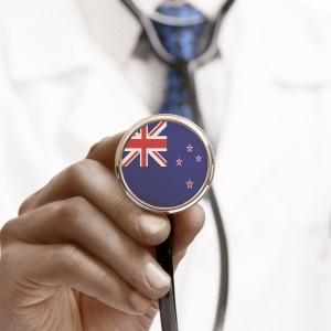 locum gp holding a stethoscope imprinted with a new zealand flag