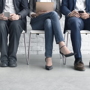 Job interview candidates sitting on chairs awaiting interviewer