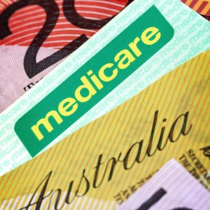 Medicare card underneath Australian money