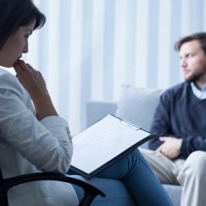 A psychiatrist assessing a patient in her office