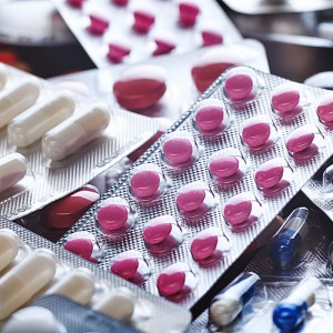 Pharmaceutical pills of different colours gathered on a table