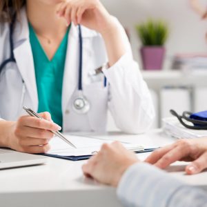 Doctor with checklist questioning patient