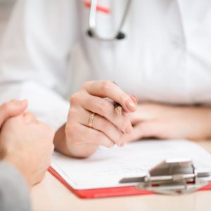 Doctor with hands over a medical form