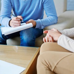 Psychologist sitting with a patient