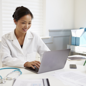 Female doctor sitting at desk smiling