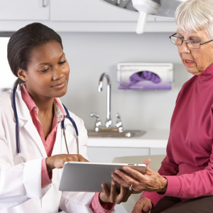 Female doctor talking to an elderly female patient