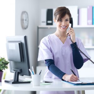 Young practitioner doctor working at the clinic reception desk