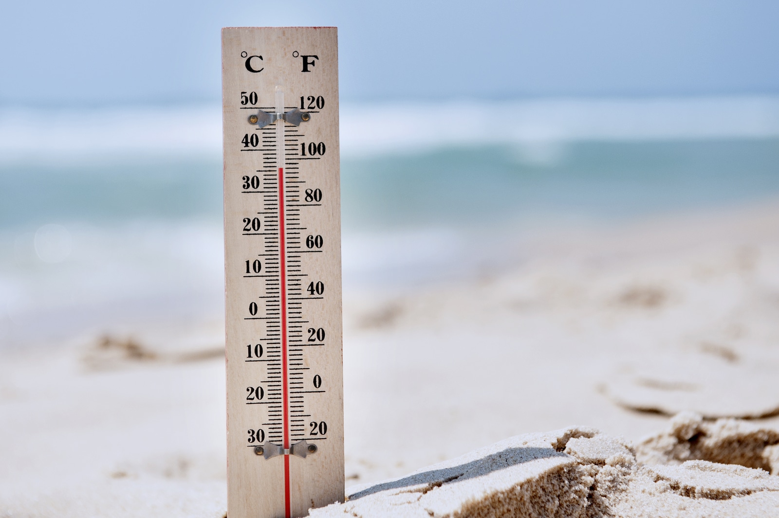 A temperature scale on a beach shows high temperatures during a heat wave