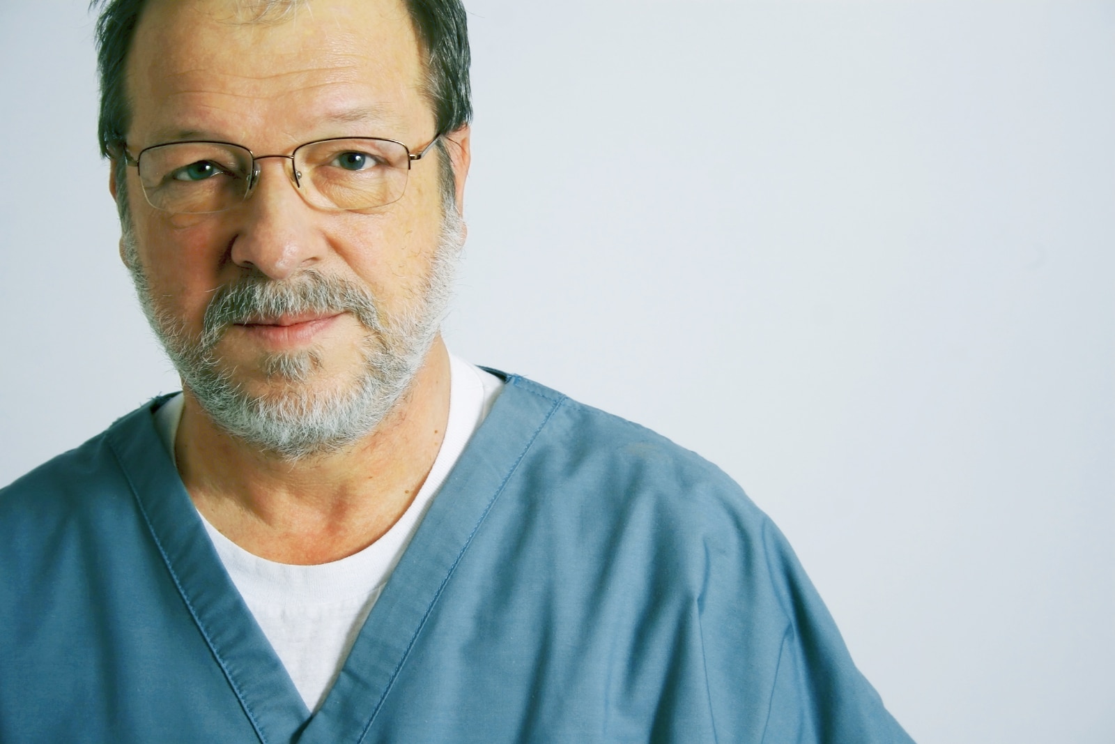 Elderly Doctor In A Green Suit