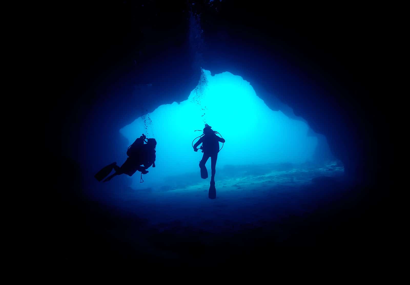 Scuba Divers in a cave. Vava'u, Tonga.
