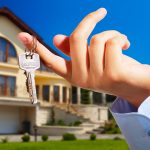 House owner/real estate agent giving away the keys - house out of focus