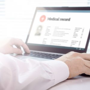 Doctor Using Laptop And Electronic Medical Record (emr) System.