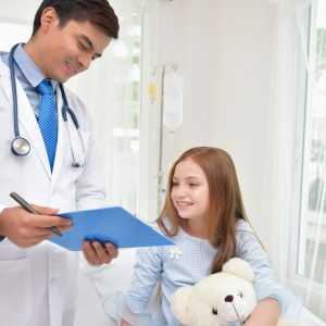 GP is examining the health of the child. The doctor is talking to the patient. Children are happy in the hospital.