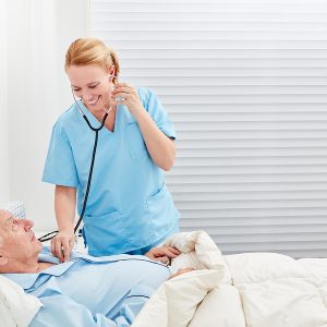 Nurse or doctor with stethoscope examines patient in hospital