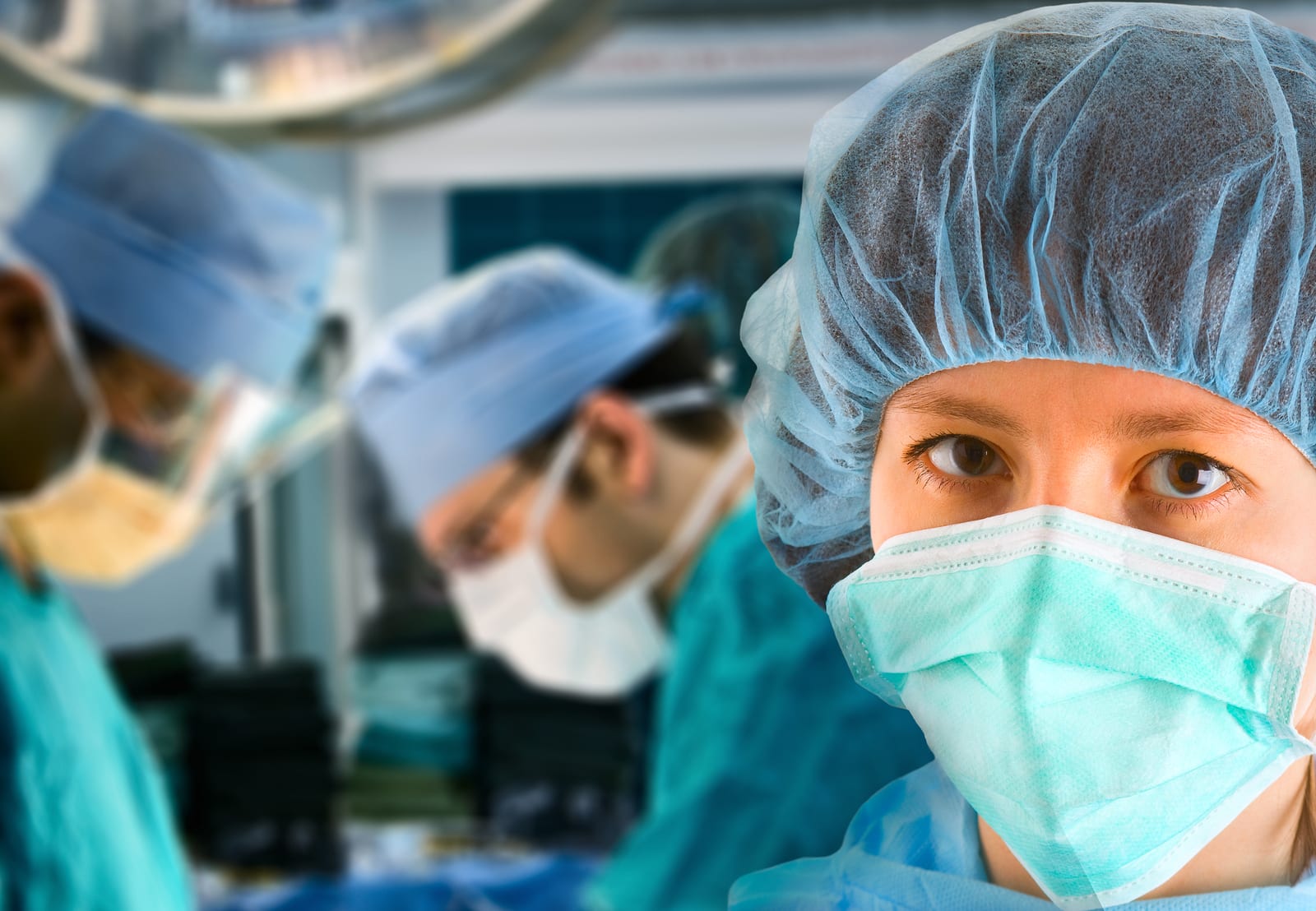female surgeon with her surgical team on background