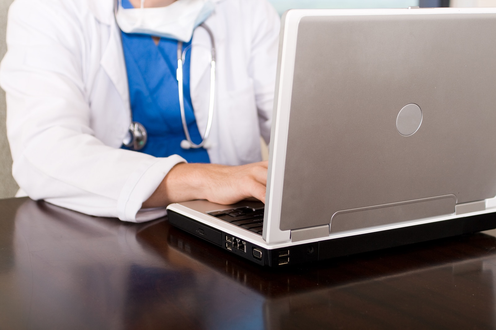 Medical doctor using laptop computer doing work