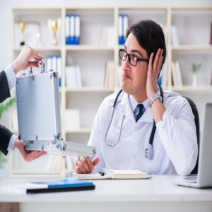 Young doctor in medical insurance fraud concept